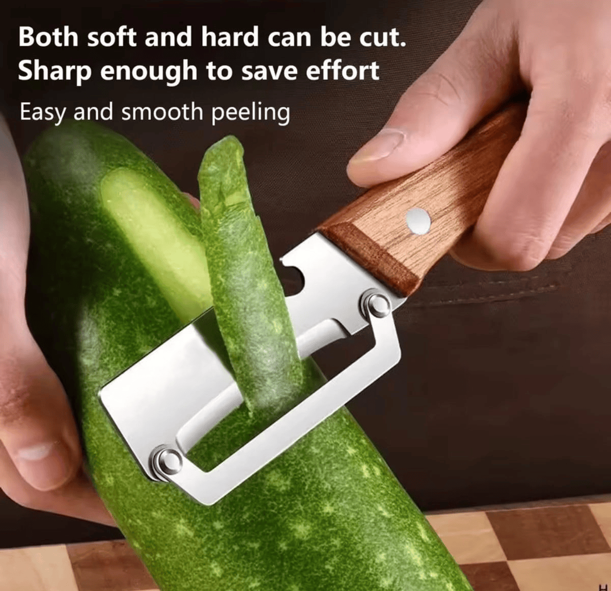Wooden handle peeler shaving a long cucumber peel in one smooth stroke