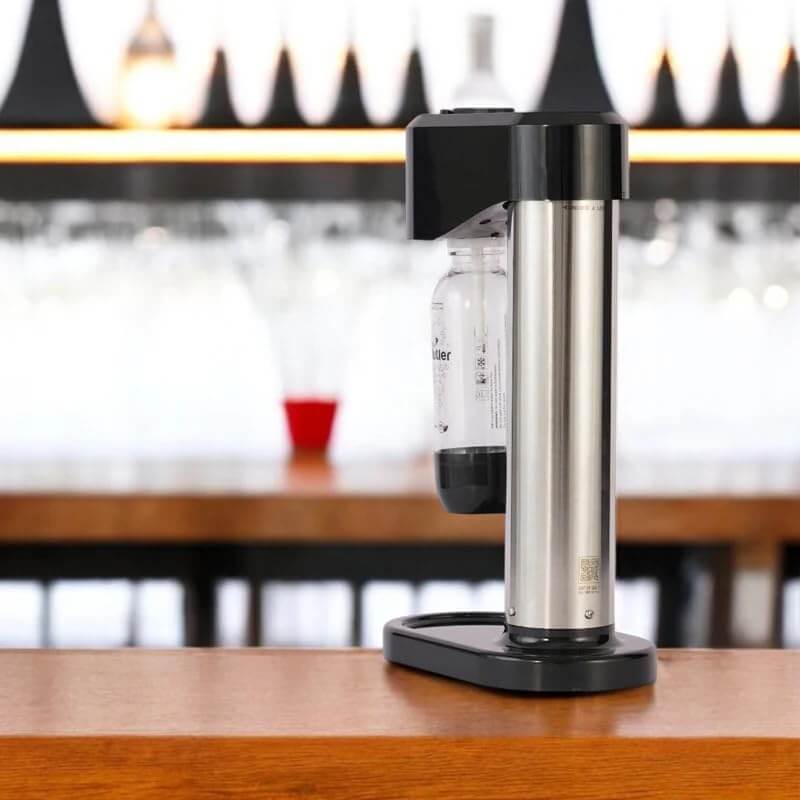 Compact single cylinder sodamaker for creating sparkling water at home kitchen countertop