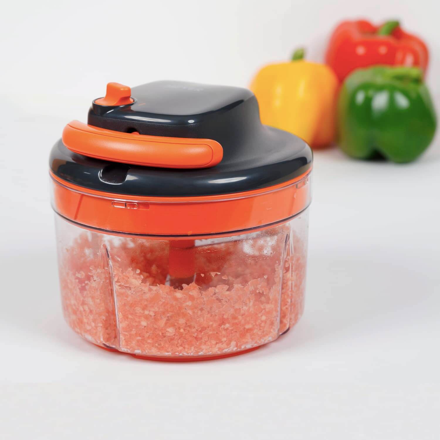 Meyer 2 Speed Pulling Chopper in orange, perfect for chopping vegetables and herbs efficiently in the kitchen.