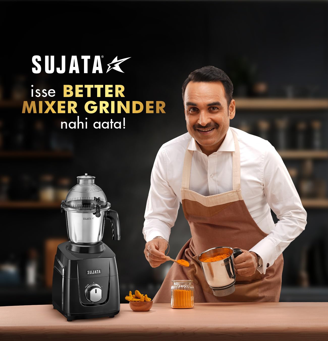 Sujata brand endorsement featuring a male spokesperson in apron presenting the mixer grinder with tagline isse better mixer grinder nahi aata in Hindi language