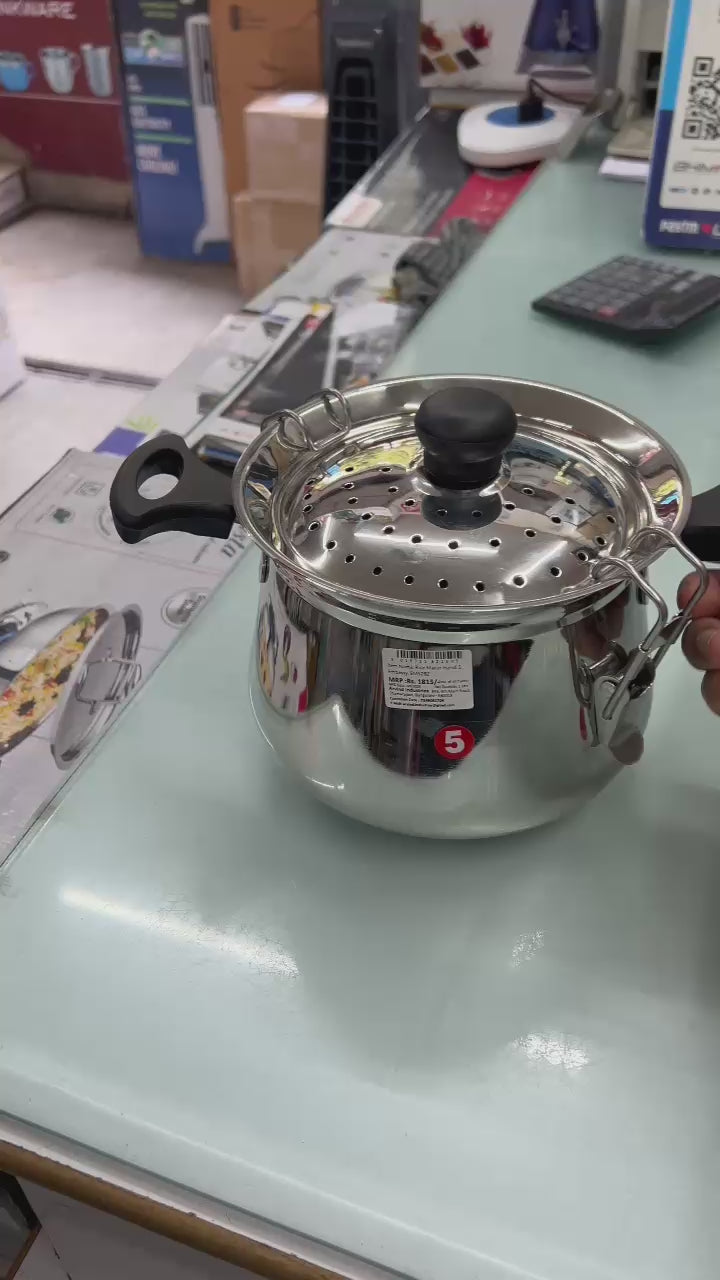 Kitchen Mart stainless steel rice maker handi with perforated lid and ergonomic handle on display.