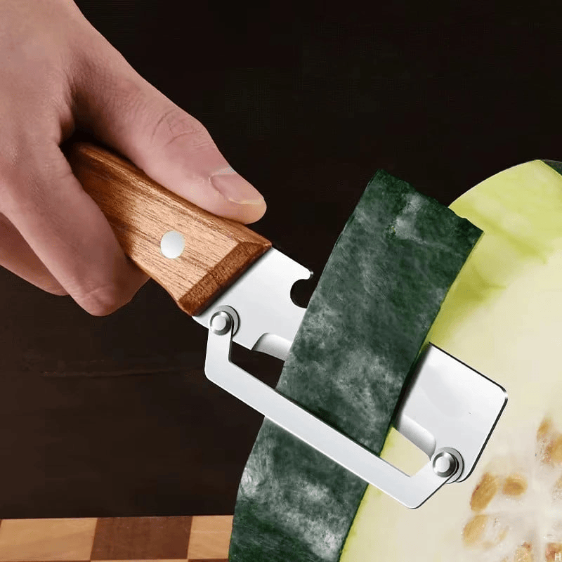Hand peeling green pumpkin skin using a wide blade stainless steel peeler