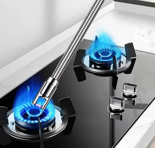 Electric rechargeable lighter igniting gas stove burners with blue flames in a modern kitchen setting.