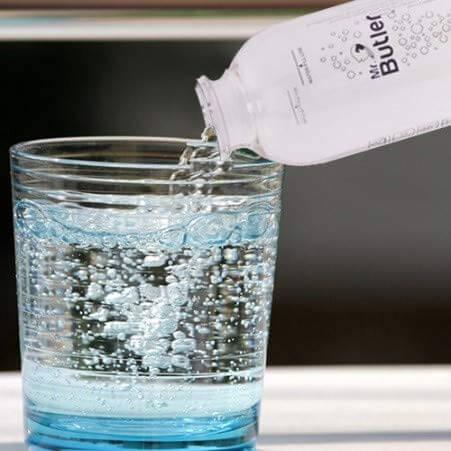 Sleek black home beverage carbonator from Mr. Butler Italia with compatible CO2 cylinder and 500ml carbonation bottle