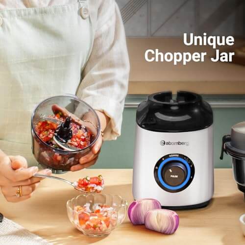 Person using Atomberg chopper jar for food preparation, showcasing unique design and functionality.