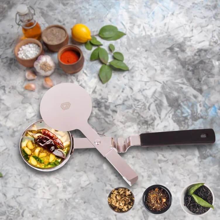 Metallic spatula with food on a textured surface surrounded by ingredients