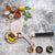Metallic spatula with food on a textured surface surrounded by ingredients