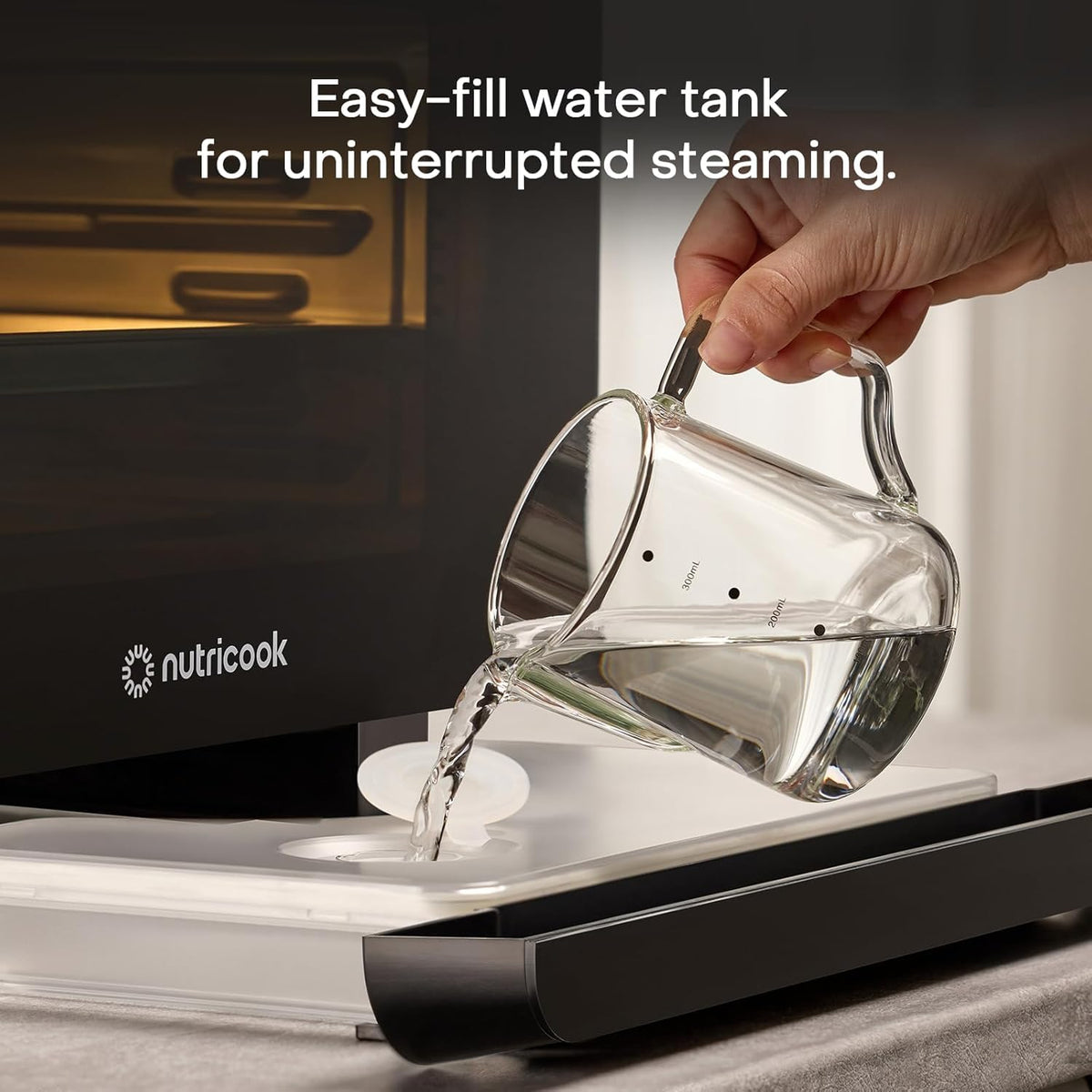 Filling the pull-out water tank of the Nutricook Steami X steam air fryer oven