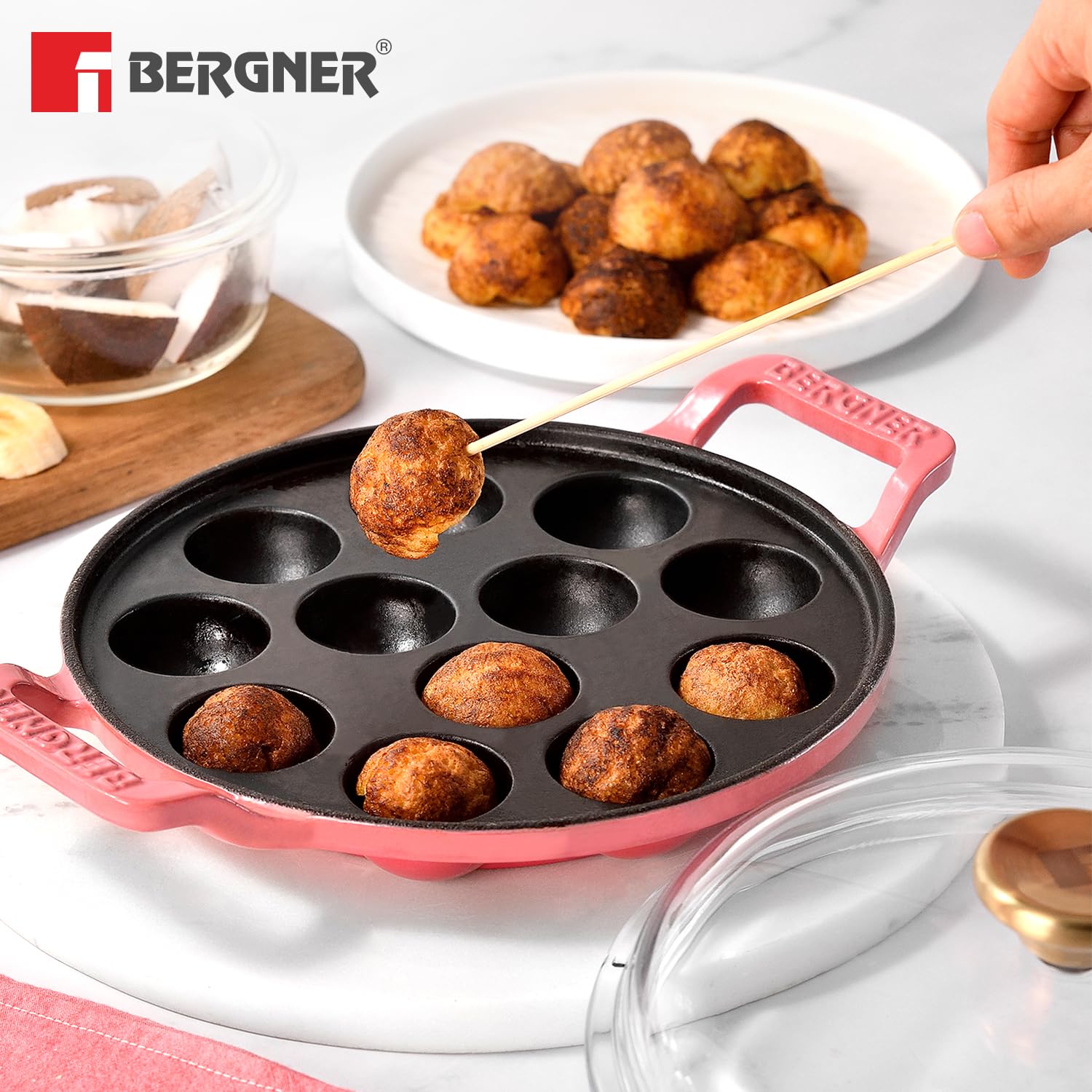 Bergner pink cast iron paniyaram pan with see-through glass lid and wooden handle
