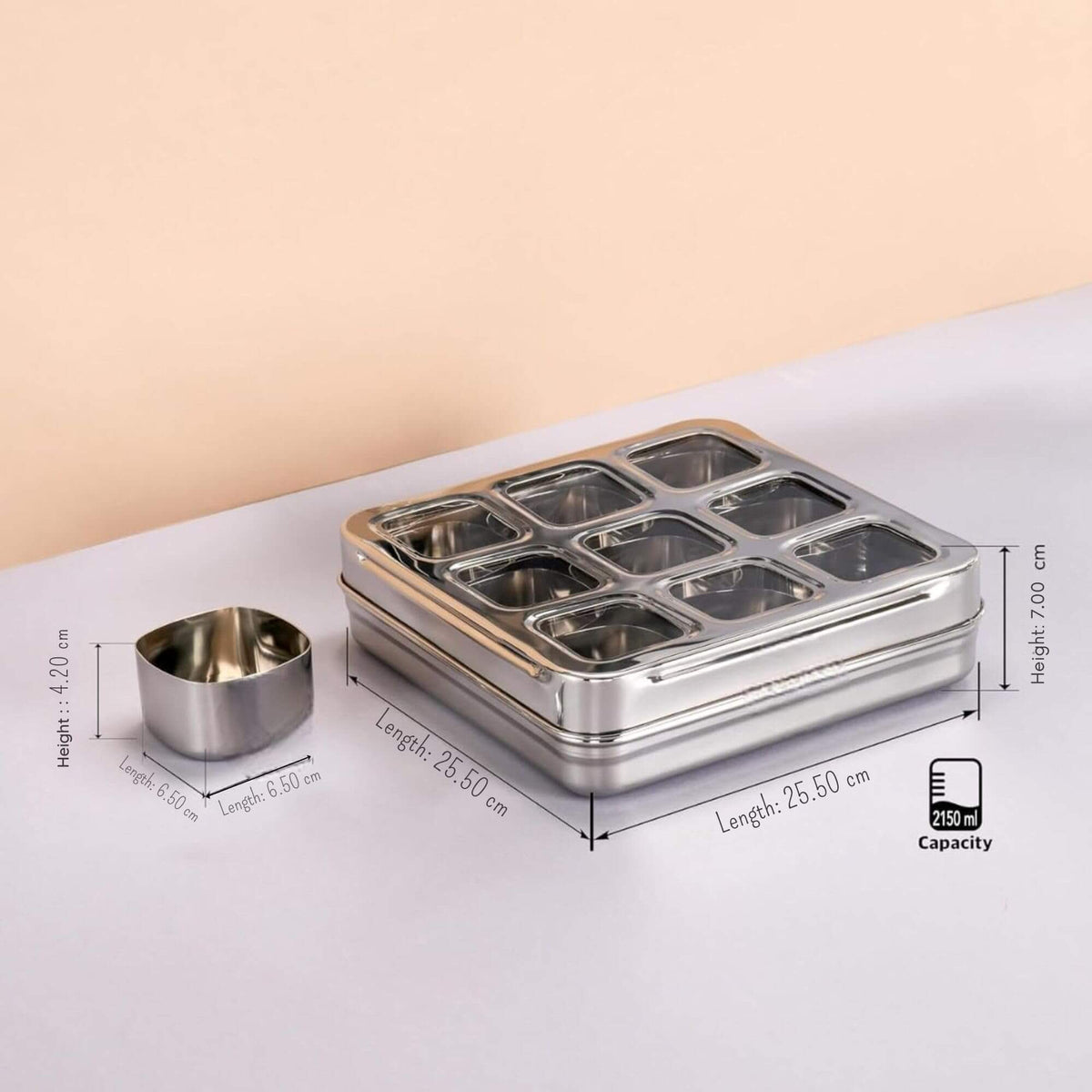 Stainless steel container with compartments and dimensions on a light background