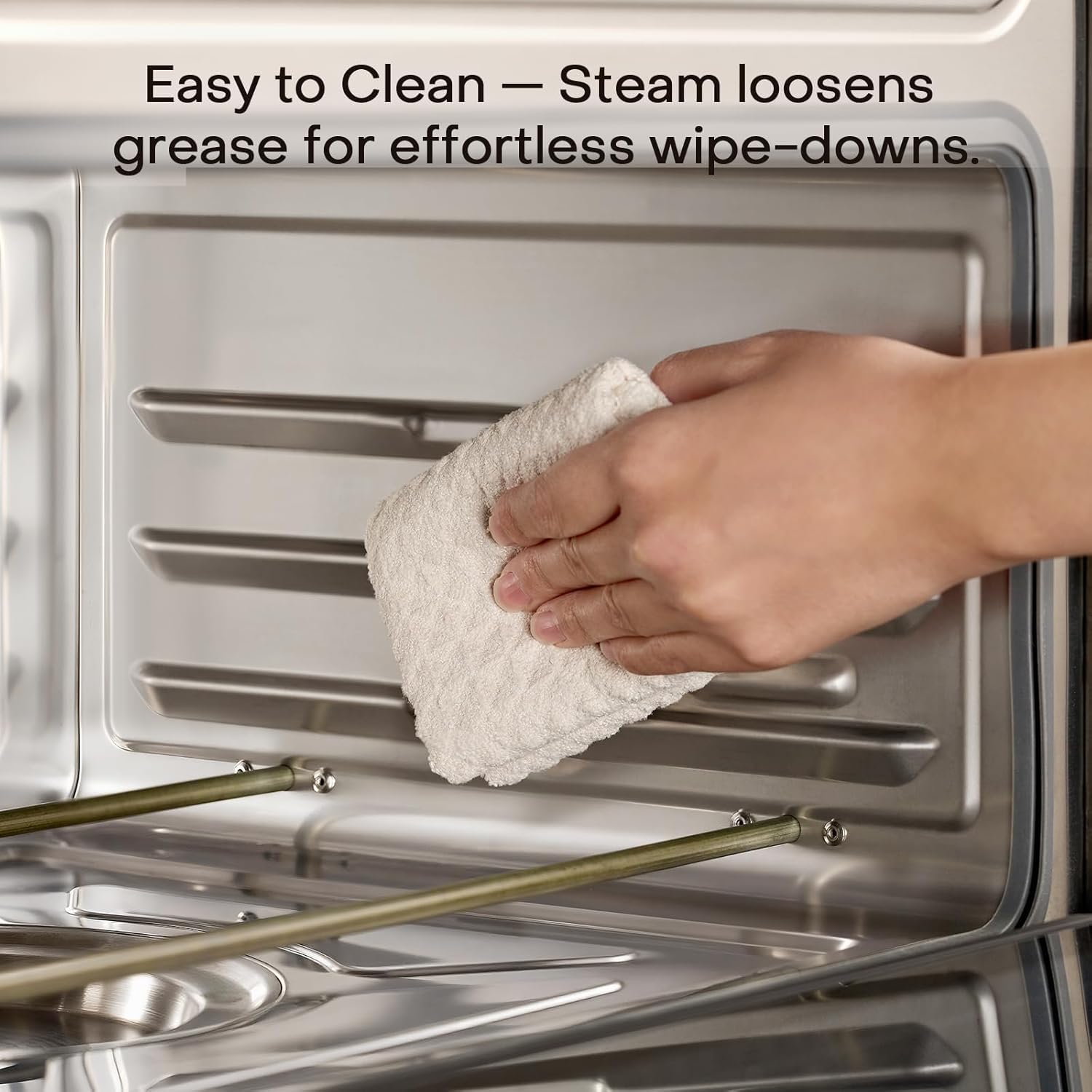 Wiping the stainless steel cavity of the Nutricook steam air fryer oven after a steam clean