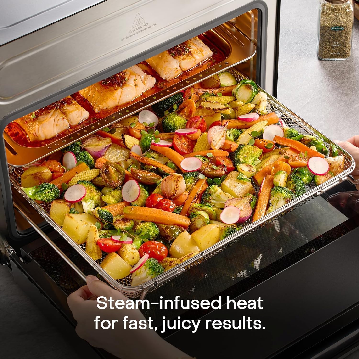 Steam air fryer oven tray of steam roasted salmon and vegetables in the Nutricook Steami X