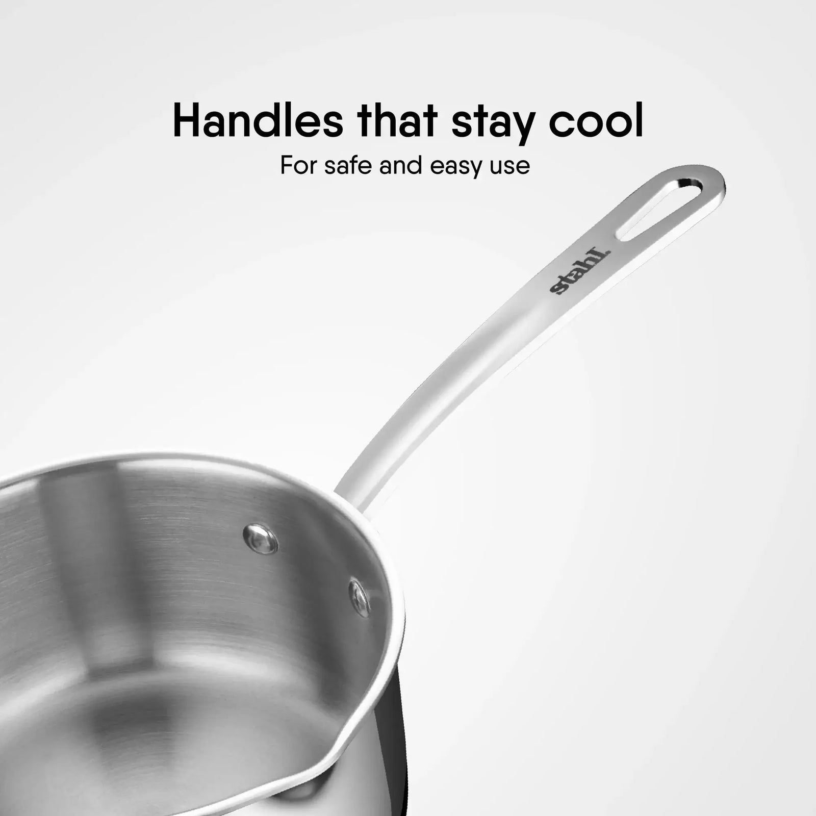 Close-up of Stahl Artisan Triply Saucepan with strainer glass lid showcasing cool-touch handles for safe cooking.