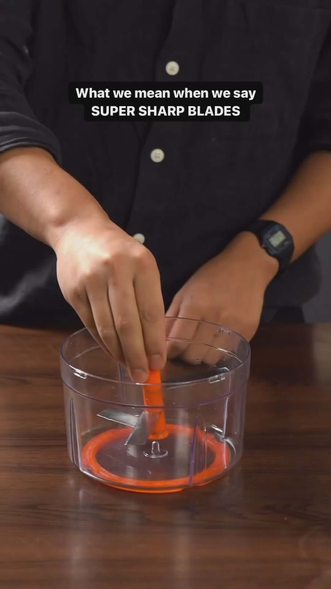 Person demonstrating super sharp blades in the Meyer 2 Speed Pulling Chopper on a wooden countertop.