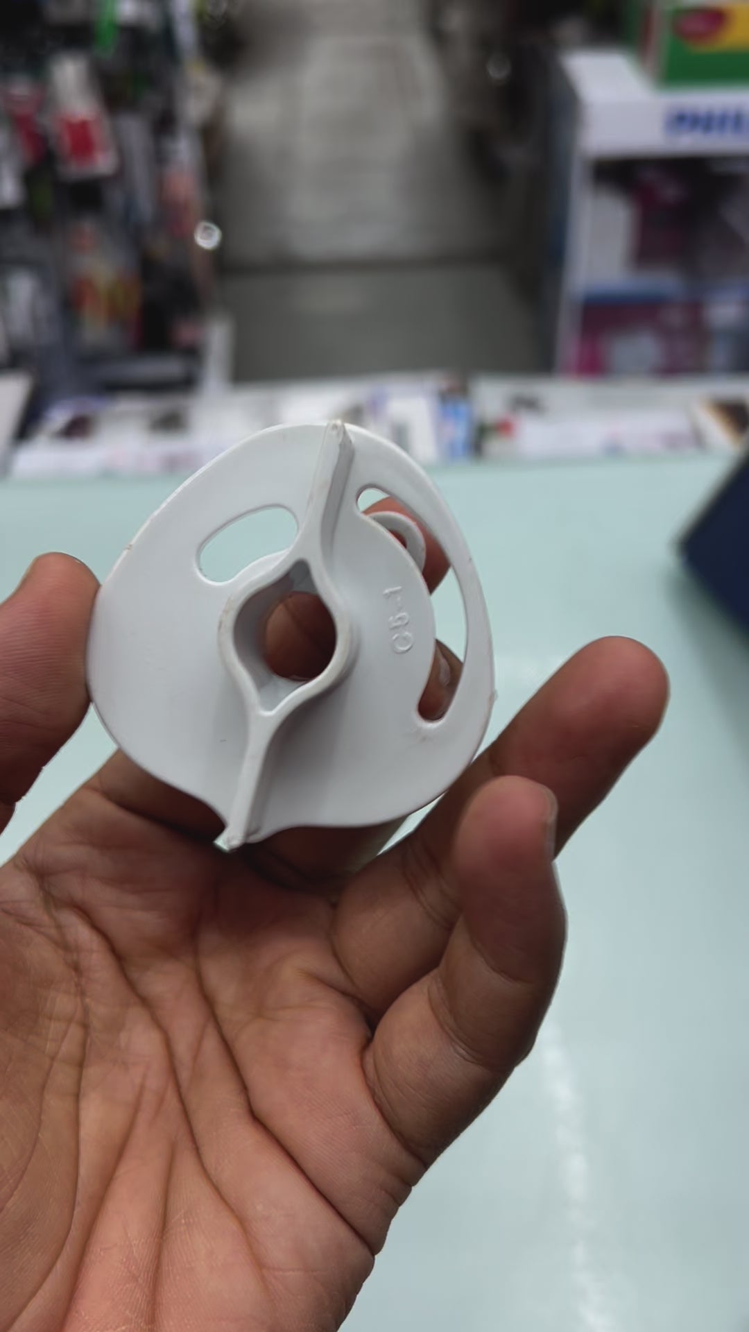 Tataswach bulb cartridge adapter held in hand, designed for Cristella and other Tataswach water purifiers.